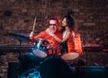 Girl hugs her idol who plays on a drum set in nightclub against a brick wall Royalty Free Stock Photo