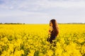 Girl hugs herself on rapeseed meadow Royalty Free Stock Photo