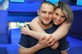 Girl hugs man and smiles in bowling of club