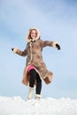 Girl hurries forward on snow and swings arms