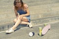 Girl hurt her leg while riding a skateboard Royalty Free Stock Photo