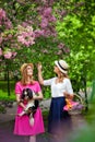 Girl and husky breed dog, Sakura blossomGirls walk in the Park with a cavalier king Charles Spaniel dog and a basket of fruit for