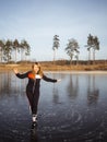 Girl ice skating on the ice of a forest lake Royalty Free Stock Photo
