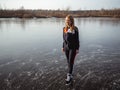 Girl ice skating on the ice of a forest lake Royalty Free Stock Photo