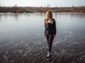 Girl ice skating on the ice of a forest lake