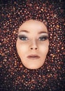 Girl immersed in coffee beans