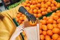Girl with implant hand taking oranges from shelf Royalty Free Stock Photo