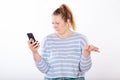 Girl indignantly studies information from the phone Royalty Free Stock Photo