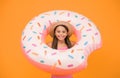 Girl with inflatable rubber ring at swimming pool. little girl going to play in water. having fun on the beach. happy