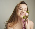 Girl with inflorescences, spring, portrait, beautiful model with a pink flower, sprouts, buds. The girl inherits the beginning Royalty Free Stock Photo