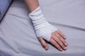 Girl with injured hand sitting on stretcher bed Royalty Free Stock Photo