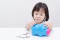 Girl insert coin into piggy bank Royalty Free Stock Photo