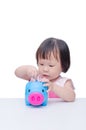 Girl insert coin into piggy bank Royalty Free Stock Photo