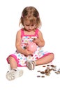 Girl Inserting Coins into Piggy Bank