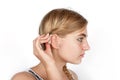 Girl inserting her hearing aid Royalty Free Stock Photo