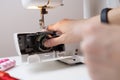 Girl inserts bobbin in sewing-machine Royalty Free Stock Photo