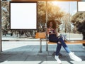 The girl inside of bus stop with cellphone, billboard mock-up Royalty Free Stock Photo