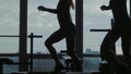 Girl with instructor do fitness exercise together using a step in sport gym