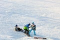 Khabarovsk, Russia - Dec 04, 2016: The girl instructor trains a teenager and a man snowboarding