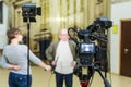 The girl interviews the man. Video shooting in the interior. LCD display on the camcorder Royalty Free Stock Photo