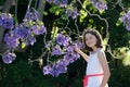 Girl with jacaranda flowers Royalty Free Stock Photo