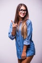 Girl in jeans shirt with glasses posing with different gesture in studio Royalty Free Stock Photo