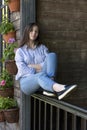 Girl in jeans sitting on the porch