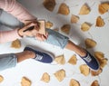 girl in jeans and sneakers sits on white background Royalty Free Stock Photo