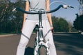 Girl in jeans and t-shirt sitting on a city bike Royalty Free Stock Photo