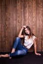 Girl in jeans and white shirt sitting down Royalty Free Stock Photo