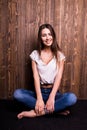 Girl in jeans and white shirt sitting down Royalty Free Stock Photo