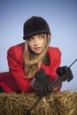 Girl jockey / on a background of blue sky and hay Royalty Free Stock Photo