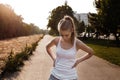 Pretty young woman loss weight and doing sport exercise outdoor Royalty Free Stock Photo