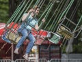 Girl with joy ride on the carousel in amusement park