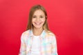 Girl joyful smiling face over red background. Emotional kid happy smiling face. Cheerful adorable girl smiling. Positive