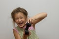 Girl with joystick. Excited little girl playing video game and smiling Royalty Free Stock Photo