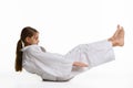 Girl judoka performs warm-up and reaches her hands to her feet