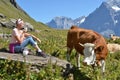 Girl with a jug of milk and a cow. Royalty Free Stock Photo