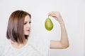 Girl with juicy pear. Young woman with fruit in her hands.