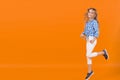 Girl jump on orange background Royalty Free Stock Photo