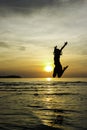 Girl jump welcome sunrise on the beach