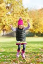 Girl jumping in autumnal park