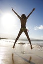 Girl jumping on beach. Royalty Free Stock Photo