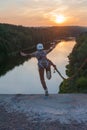 Girl jumping from the bridge. A girl with an incredible time is engaged in freestyle in bungee jumping. A young girl performs a