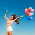 Girl jumping with colorful balloons on sky background Royalty Free Stock Photo