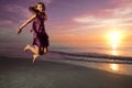 Girl jumping and dancing on beautiful beach. Royalty Free Stock Photo