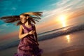 Girl jumping and dancing on beautiful beach. Royalty Free Stock Photo