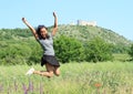 Girl jumping in front of castle Devicky on Palava Royalty Free Stock Photo