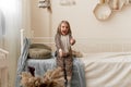 girl jumping with happiness on her bed waving her hands. Royalty Free Stock Photo