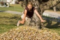 Girl Jumping into Leaf Pile Royalty Free Stock Photo